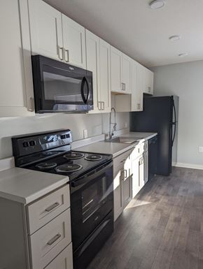 Bellevue apartment for rent - a kitchen with black appliances and white cabinets
