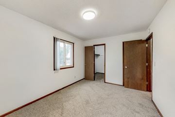 West Des Moines apartment for rent - a living room with carpet and a door to a closet