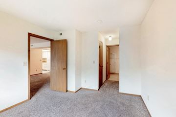 Des Moines apartment for rent - a living room with carpet and a door to a hallway