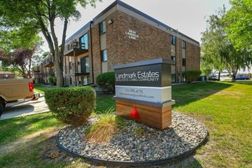 Grand Forks apartment for rent - A sign for Landmark Estates is in front of a brick building.