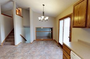 Sioux Falls townhouse for rent - A living room with a staircase and a chandelier.
