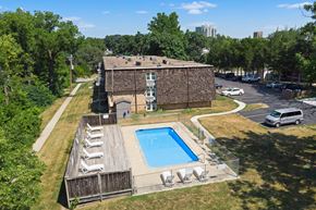 Des Moines apartment for rent - an aerial view of a pool in front of a brick building