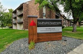 Grand Forks apartment for rent - A sign for Southwind Apartments stands in front of a brick building.