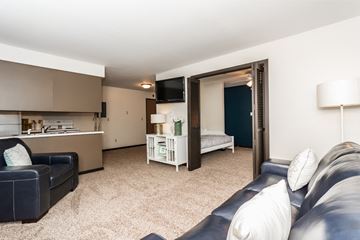 Grand Forks apartment for rent - A living room with a black couch and a white sofa.