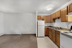 Davenport apartment for rent - a kitchen with white appliances and wooden cabinets