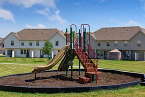 Kansas City townhouse for rent - a playground with a slide in front of a house