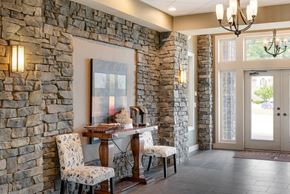 Kansas City townhouse for rent - a dining room with stone walls and a table and chairs