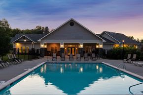 Kansas City townhouse for rent - a swimming pool in front of a house at dusk