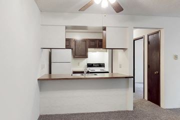 Des Moines apartment for rent - a kitchen with white cabinets and a counter and a door to a living room