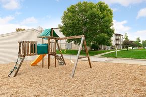 Fremont apartment for rent - a swing set in a playground next to a house