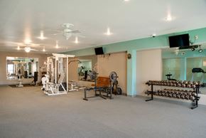 Omaha apartment for rent - a large gym with a lot of exercise equipment and a ceiling fan