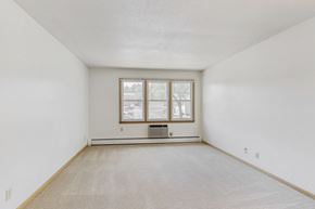 Urbandale apartment for rent - a spacious living room with white walls and a window