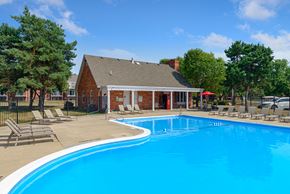 West Des Moines apartment for rent - a swimming pool with chairs around it in front of a house