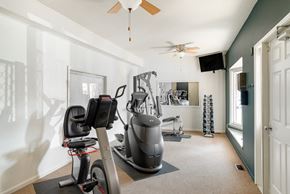 West Des Moines apartment for rent - a home gym with exercise equipment and a ceiling fan
