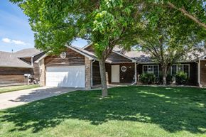 Sioux Falls townhouse for rent - A house with a white garage door and a brown wooden exterior.