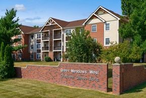 Johnston apartment for rent - a brick wall with a sign in front of an apartment building