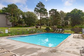 Bellevue apartment for rent - a swimming pool with chairs and a fence around it