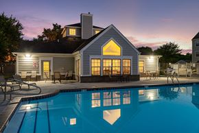 Norwalk apartment for rent - a swimming pool in front of a house at dusk