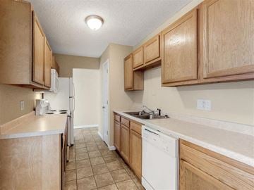 Davenport apartment for rent - a kitchen with white appliances and wooden cabinets