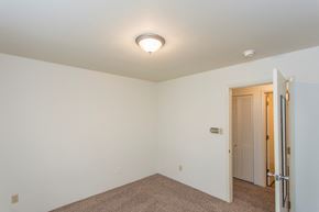 Des Moines apartment for rent - a bedroom with white walls and a door to a closet