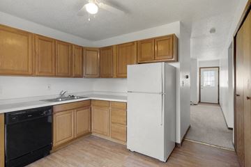 Davenport apartment for rent - a kitchen with a white refrigerator and wooden cabinets