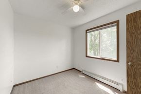 Davenport apartment for rent - a bedroom with white walls and a window and a ceiling fan