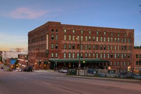 Omaha apartment for rent - a large brick building on the corner of a city street
