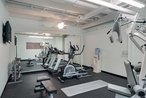 Omaha apartment for rent - a gym with cardio machines and other equipment in a building