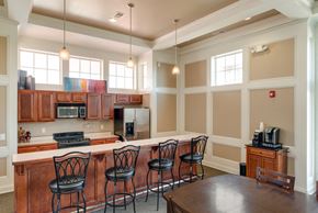 West Des Moines apartment for rent - a kitchen with a bar and a table with chairs