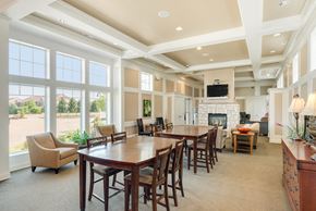 West Des Moines apartment for rent - a large dining room with a table and chairs and a fireplace