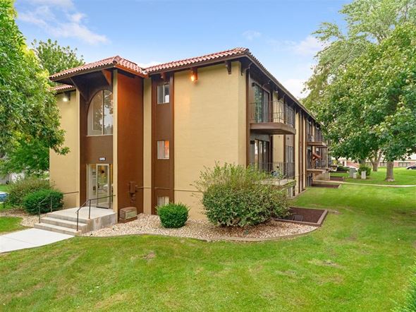 Omaha apartment for rent - the front of a building with grass and trees