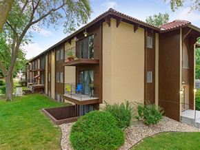 Omaha apartment for rent - a home with a porch and a grass yard