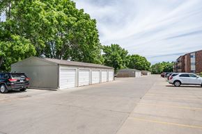 Sioux Falls apartment for rent - A parking lot with a building and cars.