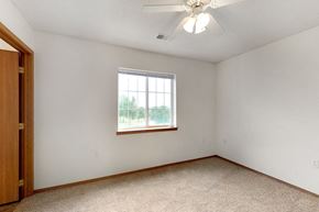 Sioux Falls apartment for rent - an empty bedroom with a window and a ceiling fan