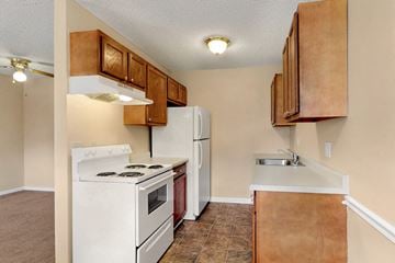 Davenport apartment for rent - a kitchen with white appliances and wooden cabinets