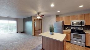 Sioux Falls apartment for rent - A kitchen with a refrigerator, microwave, and oven.