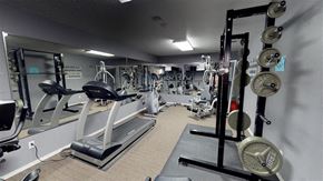 Sioux Falls apartment for rent - A gym with a variety of equipment including weights and treadmills.