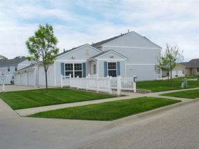 Sioux Falls townhouse for rent - A white house with a blue trim and a white fence.
