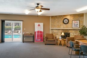Urbandale apartment for rent - a living room with a fireplace and a door to a swimming pool
