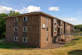 Des Moines apartment for rent - a brick apartment building with a balcony and a bridge