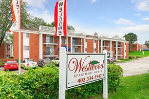 Omaha apartment for rent - a building with a sign in front of it