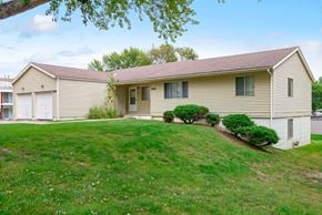 Omaha apartment for rent - a home with a lawn and a garage