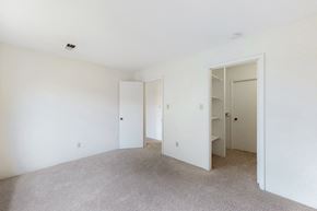 Urbandale apartment for rent - a bedroom with white walls and carpet and a closet