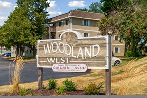 West Des Moines apartment for rent - a sign for woodland west in front of a house
