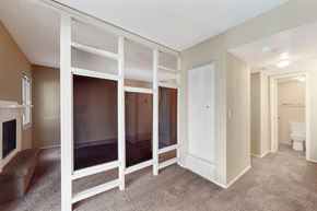 Omaha apartment for rent - a walk in closet with mirrored sliding doors in a renovated living room