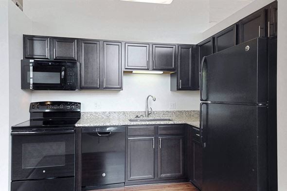 Omaha apartment for rent - a kitchen with black appliances and granite counter tops