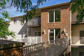 Plattsmouth apartment for rent - an apartment building with a balcony and a wooden deck