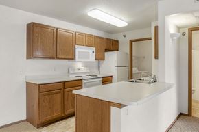 Sioux Falls apartment for rent - a kitchen with a white counter top and wooden cabinets