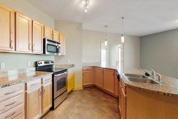 Omaha apartment for rent - a kitchen with wooden cabinets and a sink
