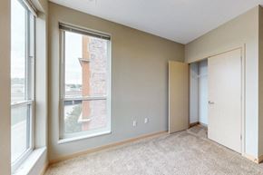 Omaha apartment for rent - a bedroom with a large window and a door to a closet